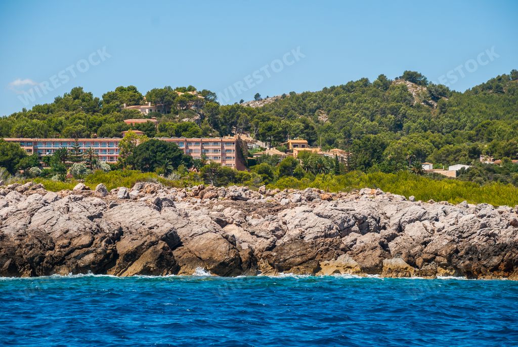 The blue sky over the hills and the coastal buildings in Mallorca, Spain