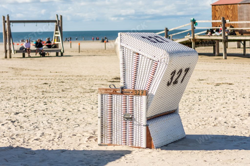 A cabin on the sandy shore in the St. Peter-Ording Germany with the North Sea in the background