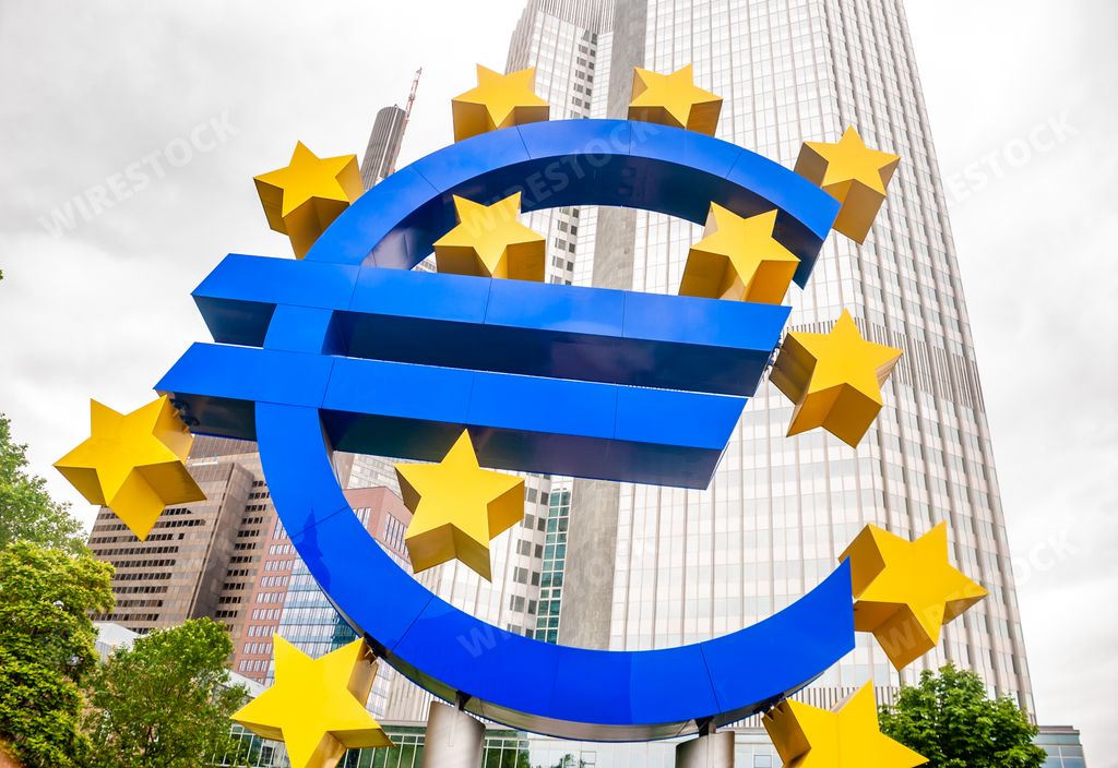 A low angle of a large euro sign in front of a euro tower in Germany during a cloudy day
