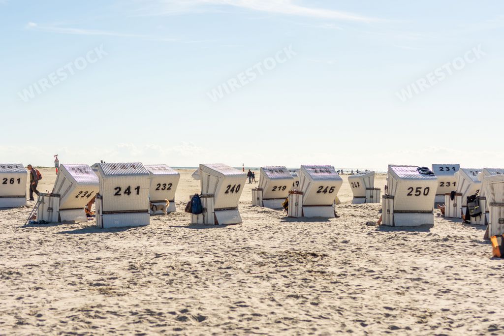 The cabins on the sandy shore in the St. Peter-Ording Germany with the North Sea in the background