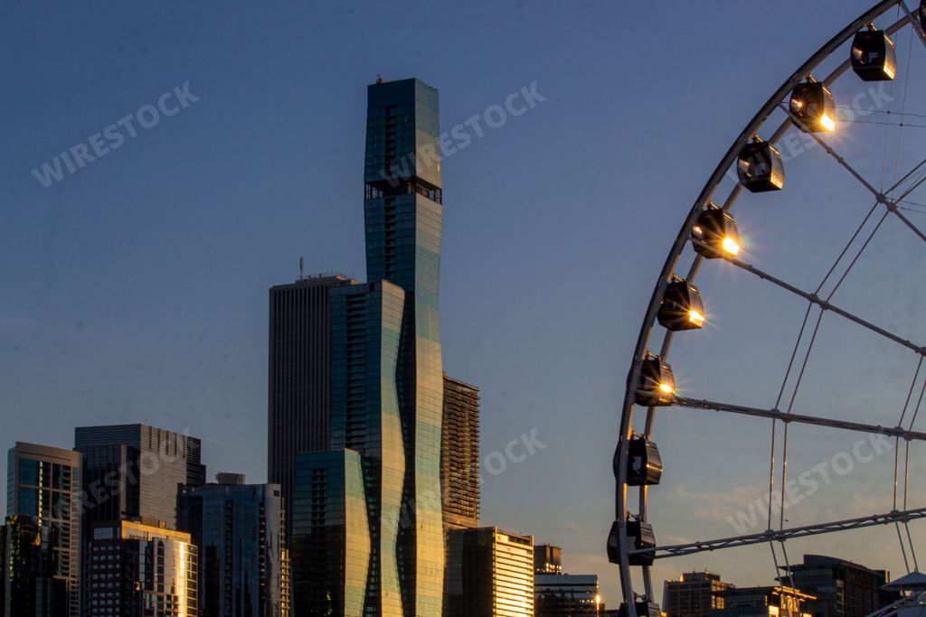 A Ferris wheel with city skyline against sunset at Navy Pier,Chicago