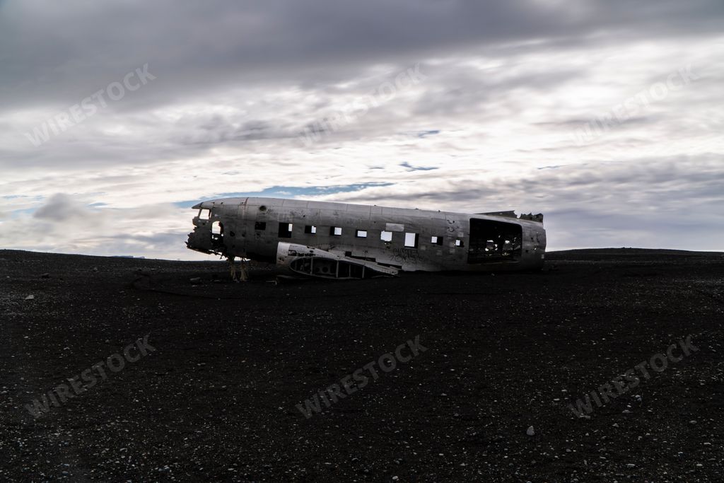 An abandoned plane wreck in a black sand beach in Iceland