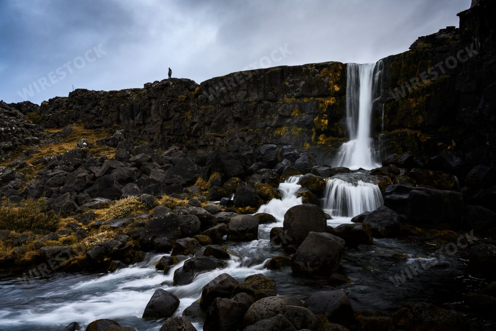 A low angle shot of the beautiful flowing Oxarafoss waterfall in Iceland