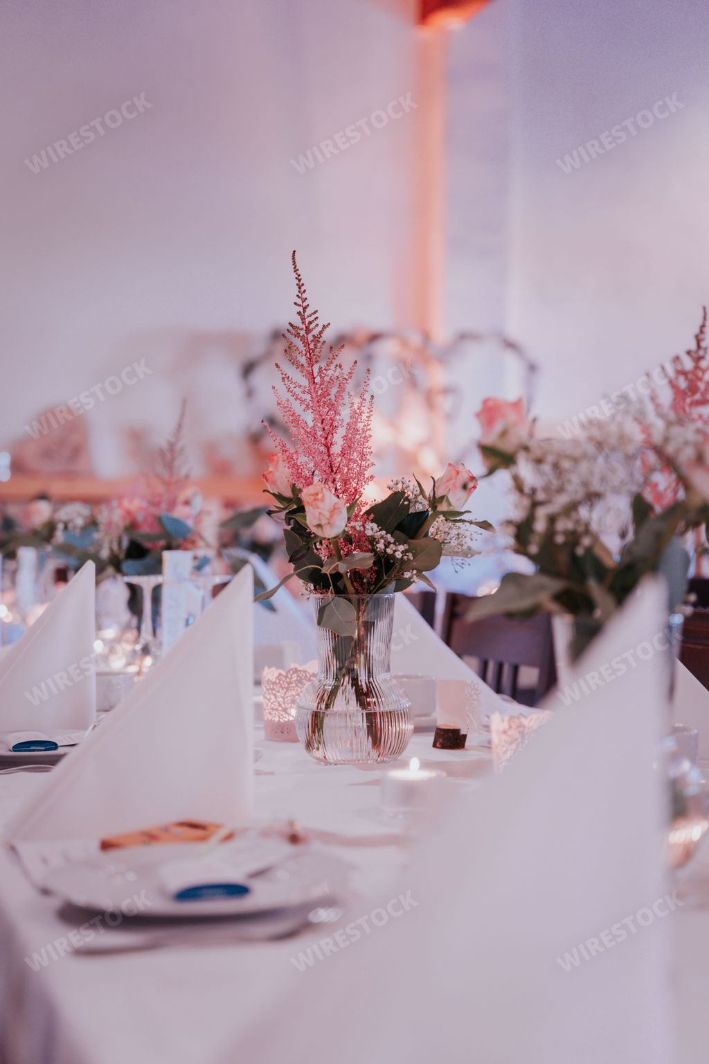An elegant banquet table with white napkins, perfect for a special occasion or gathering