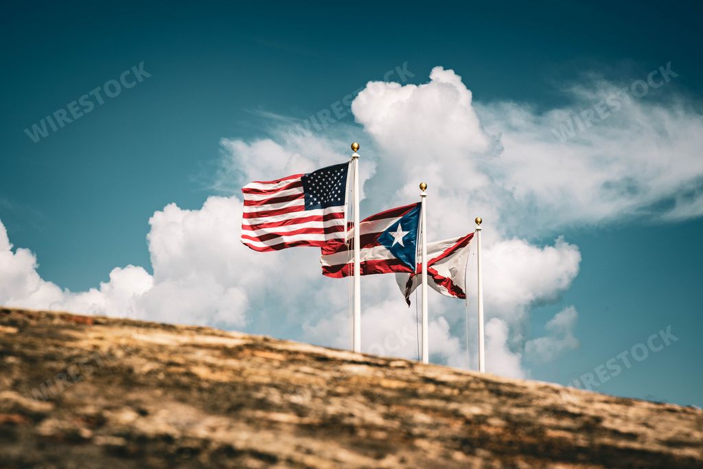 A closeup shot of Puerto Rico, Cross of Burgundy and American flags on the top of El Morro