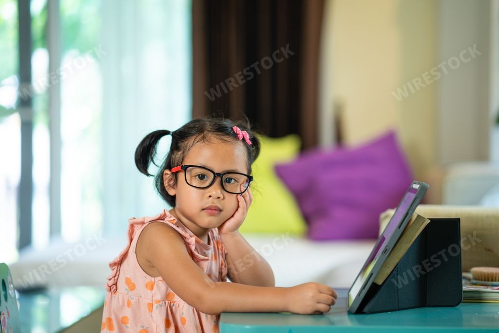 A closeup shot of a cute South Asian child studying at home