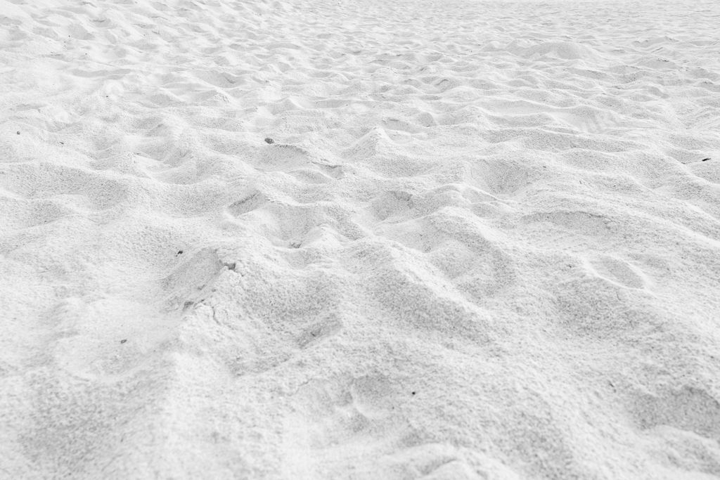 A closeup of fine white beach sand texture