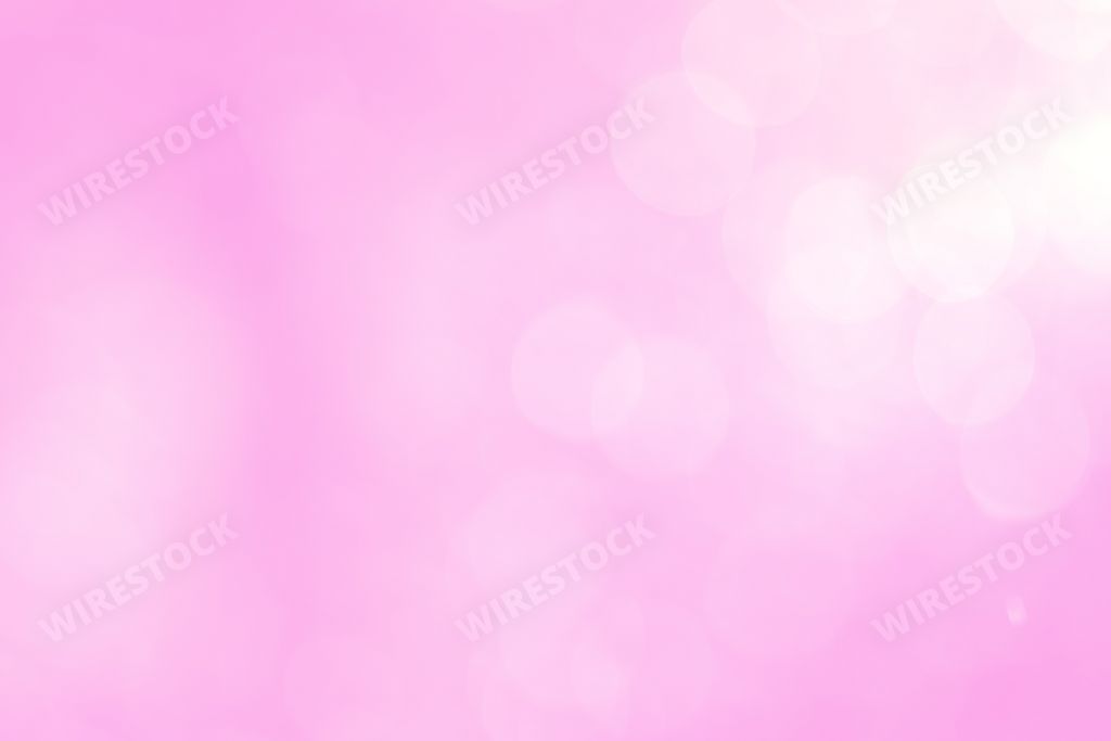 A gradient pink background with white bokeh lights
