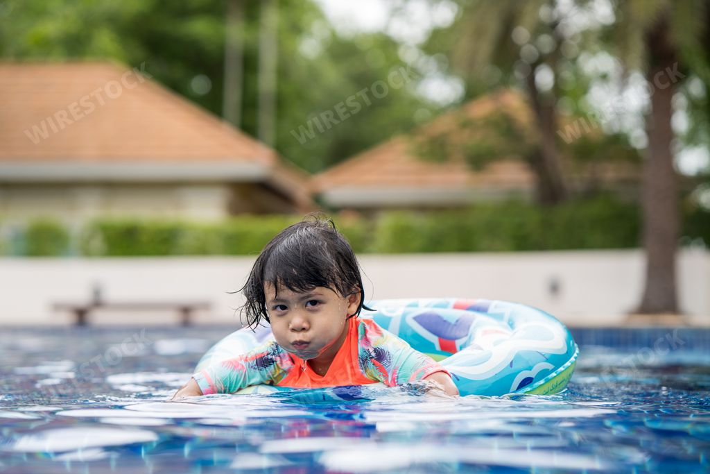 A closeup shot of an Asian child on a swimming pool