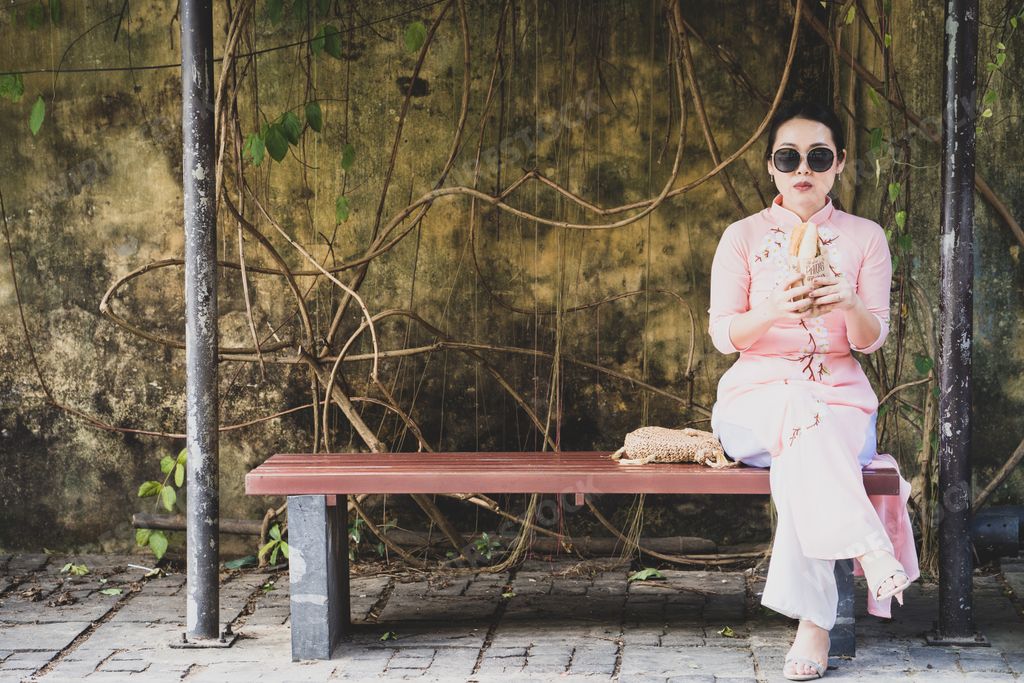 A beautiful Asian woman with fashionable sunglasses sitting in a park, Thailand