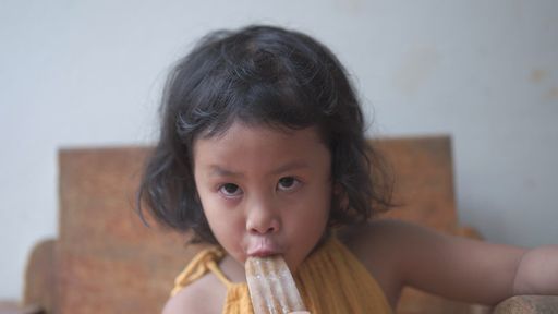 Little cute short-haired Thai girl enjoying an ice-cream Stock ...