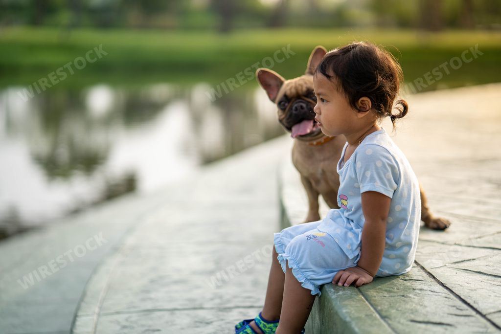 A Southeast Asian cute baby girl with her adorable French bulldog