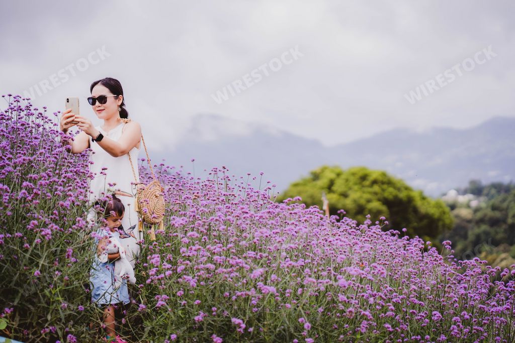 A happy Asian mother spending time with her daughter in a Mon Jam garden in Chiang Mai, Thailand