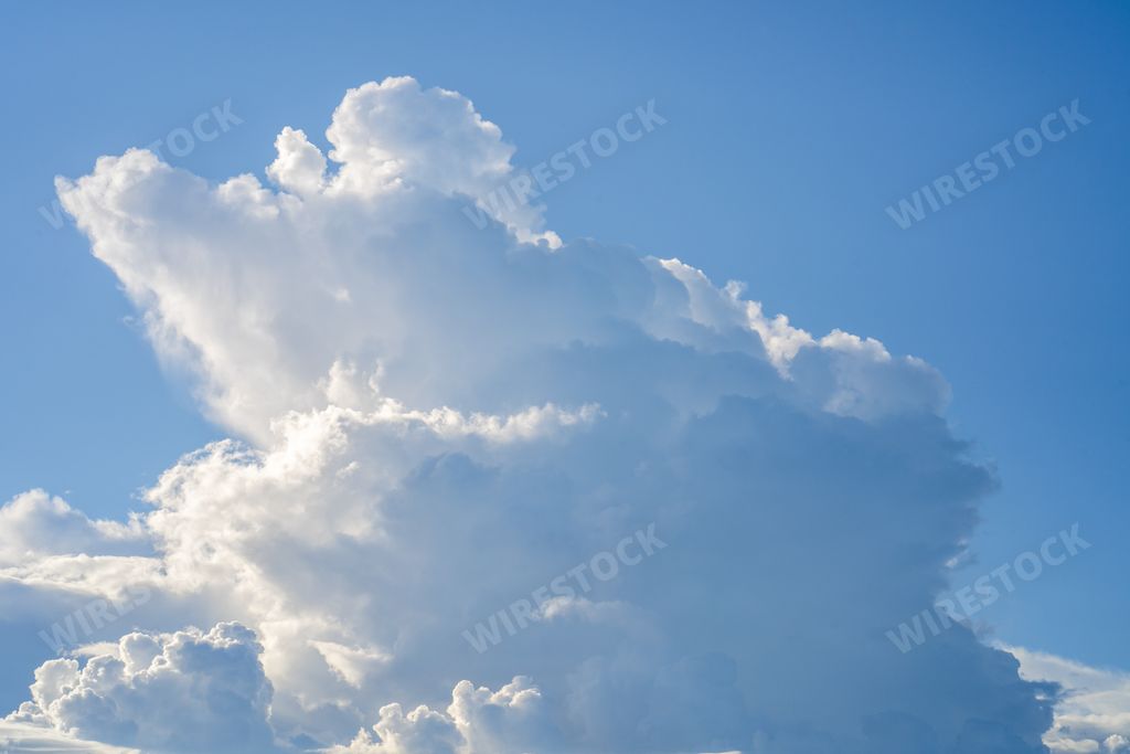 A closeup shot of white fluffy clouds on a blue sky - perfect for wallpaper