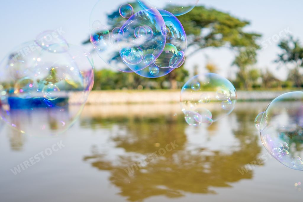 A closeup shot of floating soap bubbles on the water surface