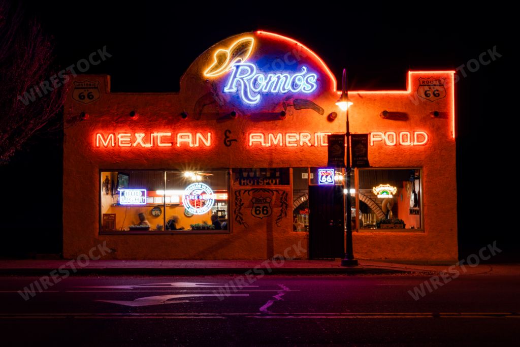 A closeup of a Mexican restaurant at night with glowing neon signs in Holbrook, Arizona.