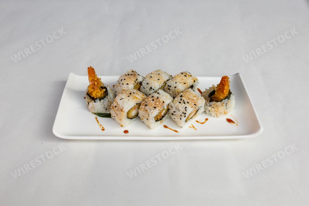 A closeup  of sushi set on a white plate on a white background