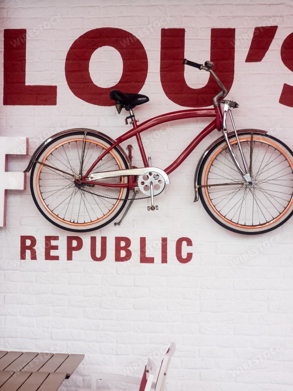 A vertical shot of the exterior of a fast-food restaurant with a red bicycle on its facade in Santa Cruz de Tenerife, Spain
