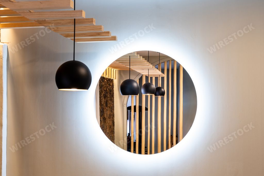 An interior view of a restaurant with lamps hanging on the ceiling