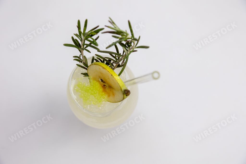 A top view shot of a fresh apple juice with bubbles and rosemary