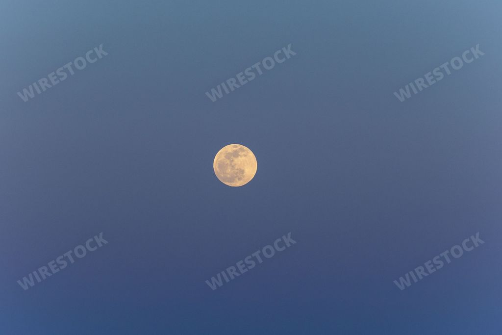 A beautiful view of a clear purple sky with a full moon
