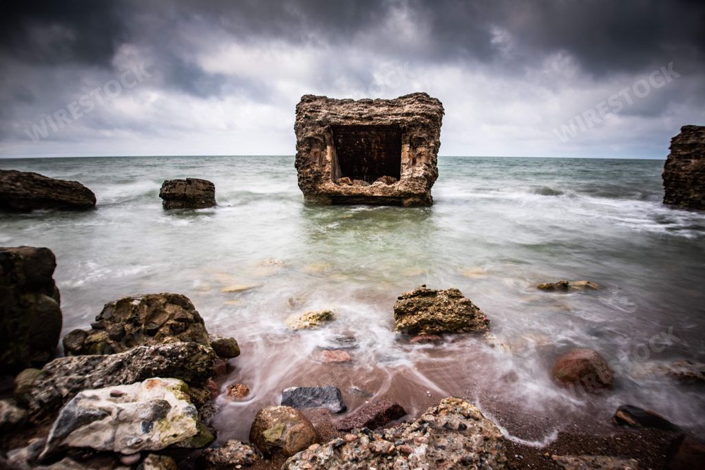 The front view of the Northern Fort in Liepaja, Latvia in a sea surrounded by stones