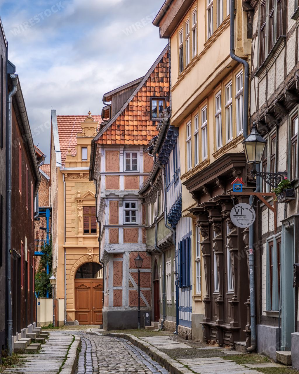 A cobblestone street with historic buildings in Quedlinburg, Germany