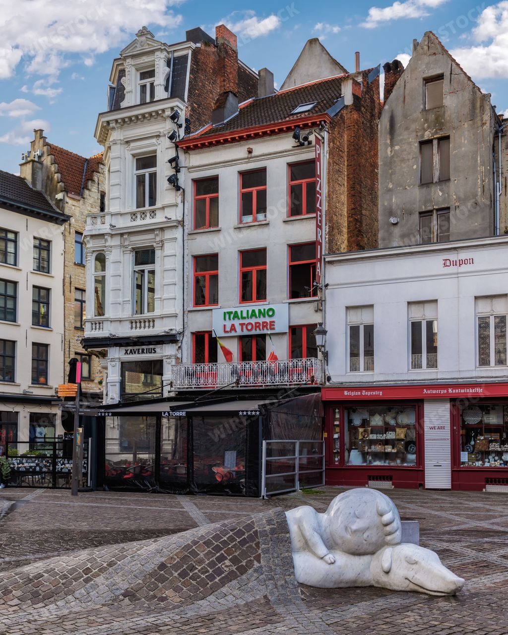 The Nello & Patrache statue in Antwerp, Belgium, in front of a picturesque background