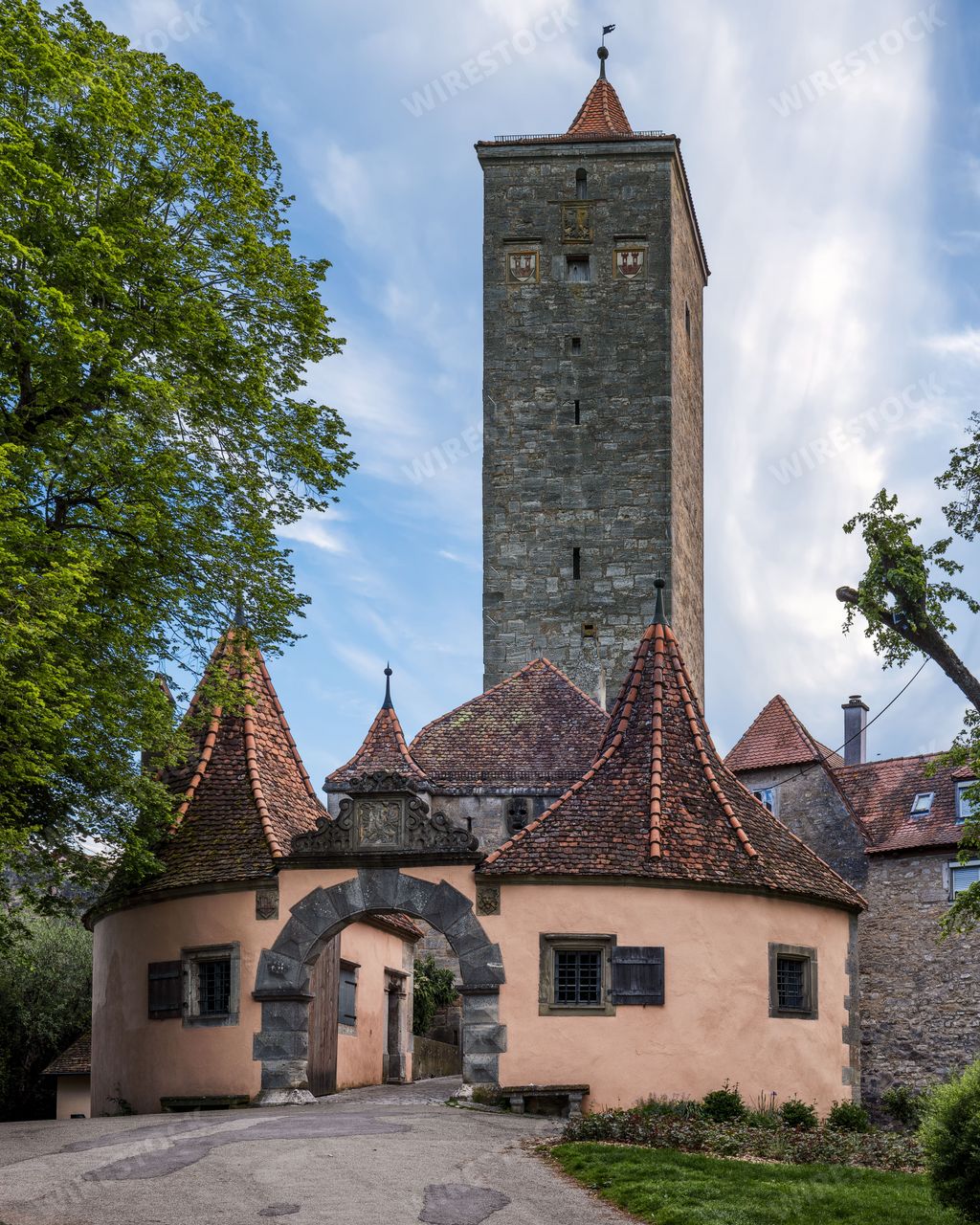 The historical Burg gatehouse with a tall stone tower on a sunny day in Rothenburg Ob der Tauber, Bavaria, Franconia, Germany