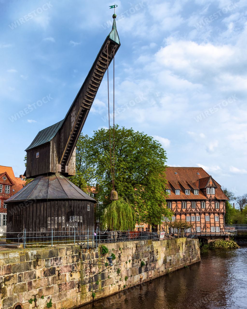 The historic crane and half-timbered buildings along the Ilmenau River in Luneburg, Germany