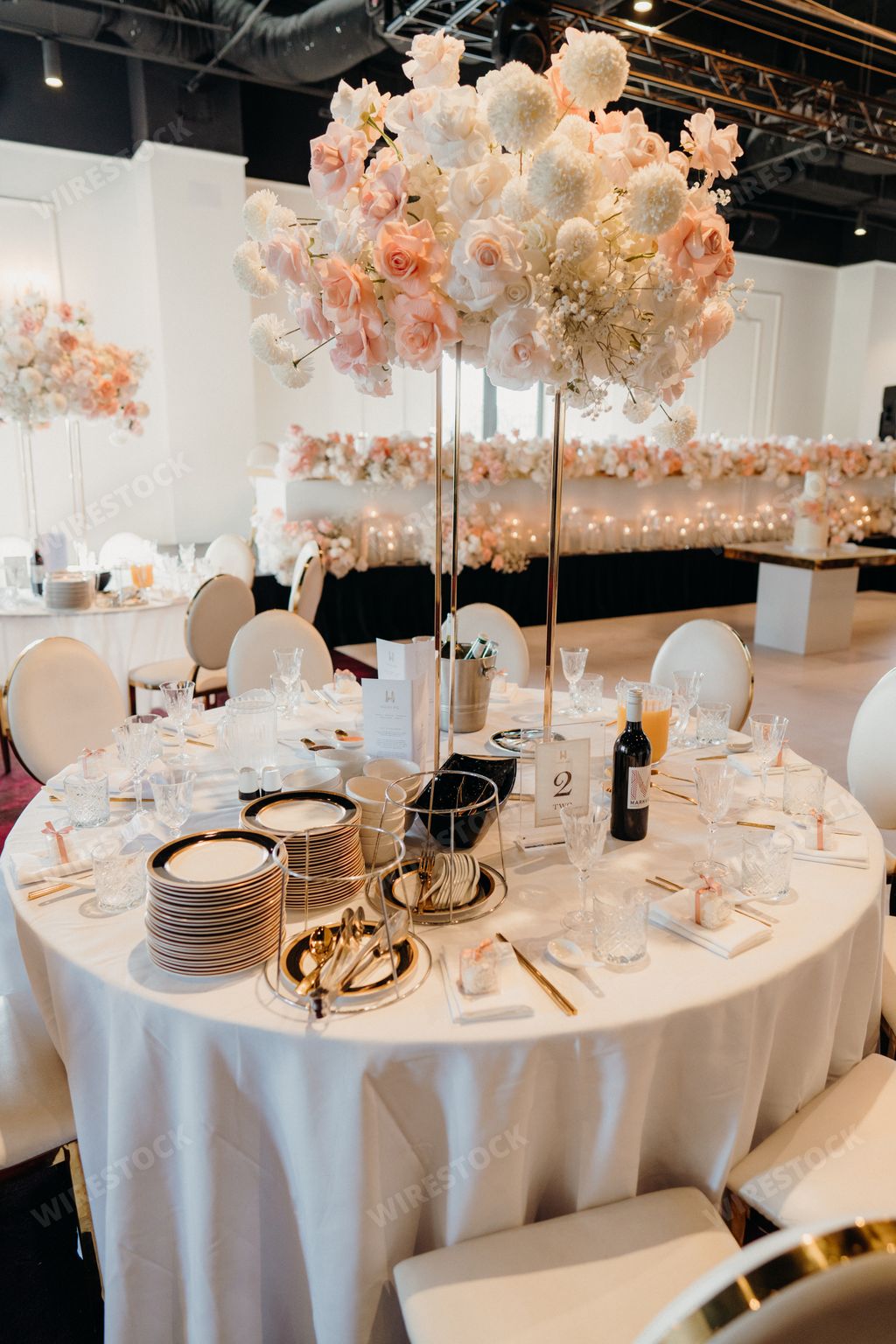 Elegantly decorated banquet hall with place settings and floral centerpieces