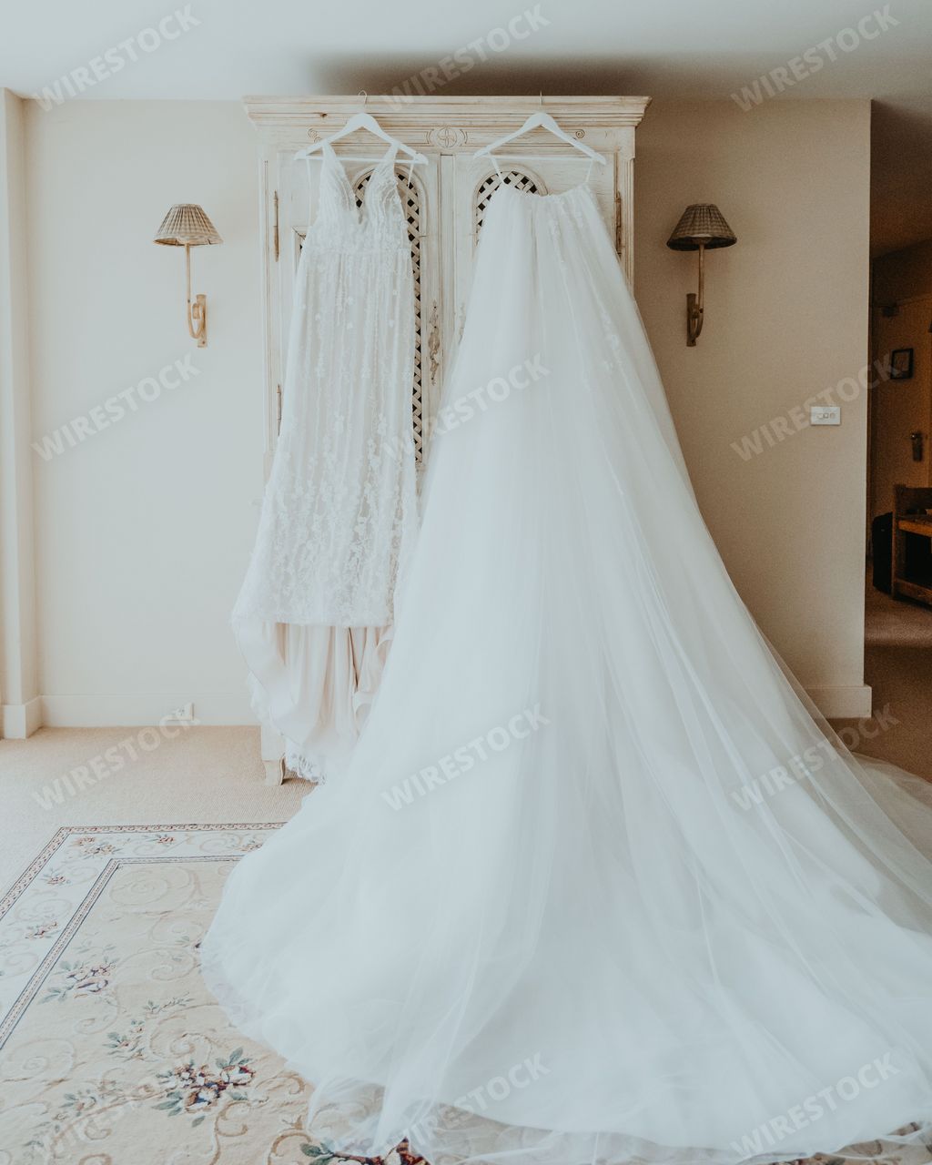 A wedding dress hanging on a rack in a bridal room