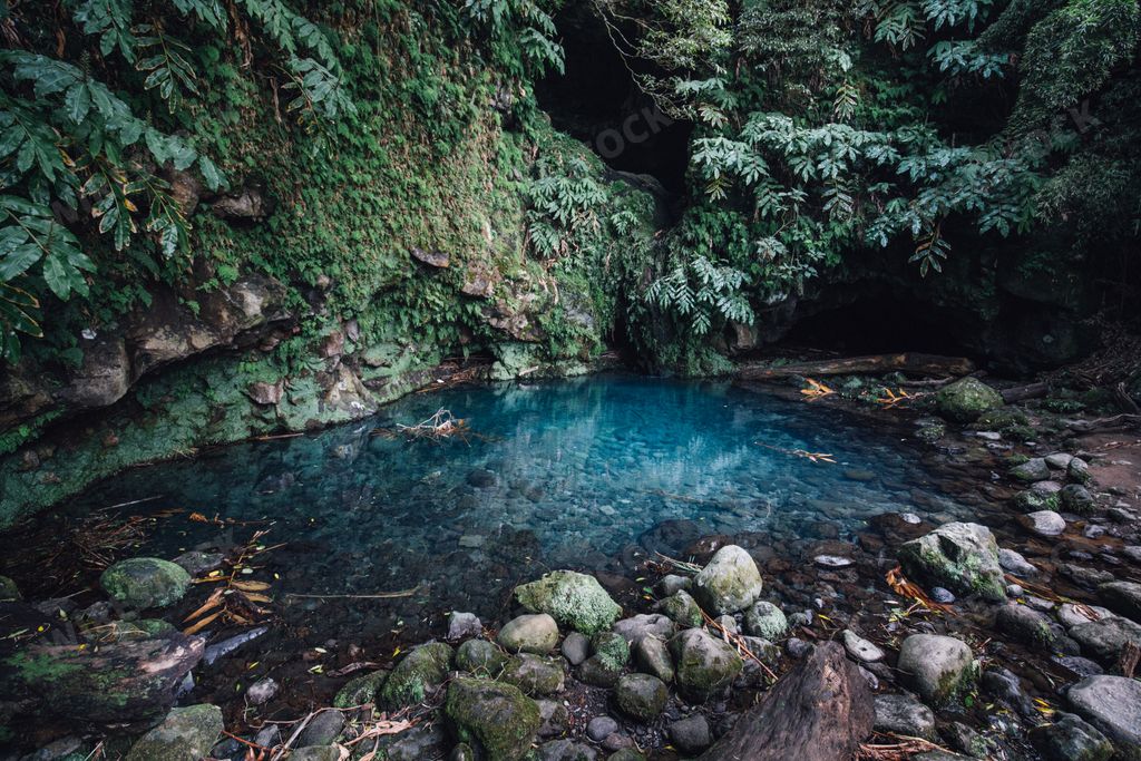 A beautiful shot of a small blue pond in the middle of a jungle in Poco Azul