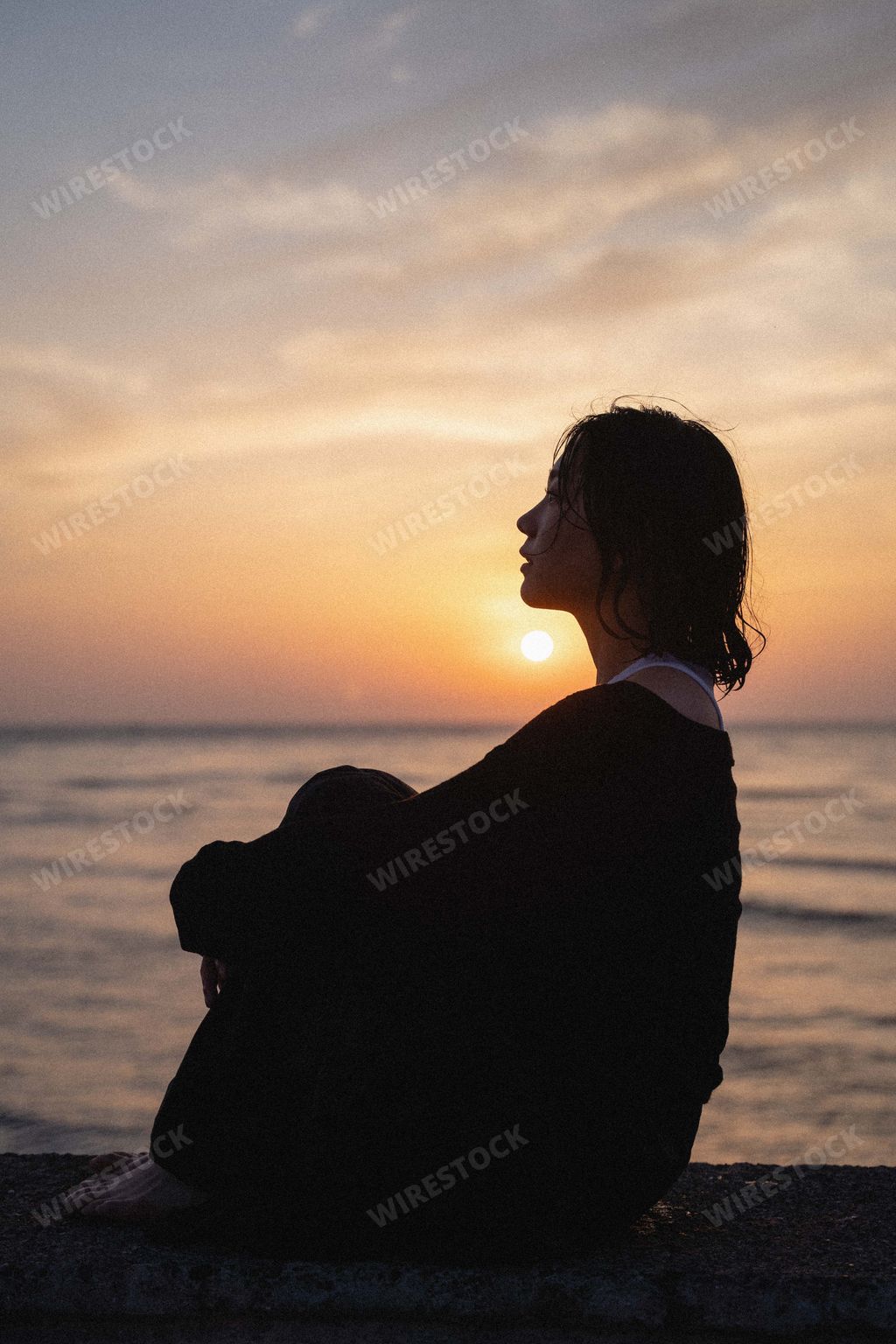 A beautiful South Korean female against a sunset