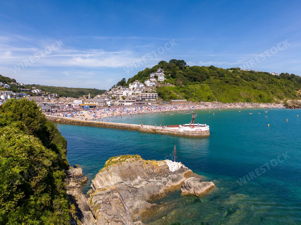 An aerial view of the Banjo Fishing Pier and Looe Beach on a sunny day in Looe town, Cornwall, England, UK