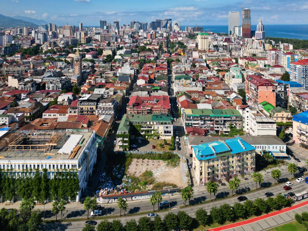 An aerial shot of a stunning beach in Batumi, Georgia with a backdrop of modern skyscrapers.