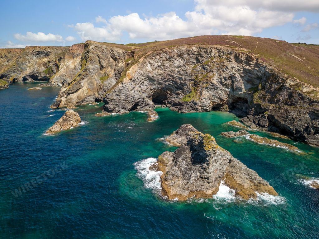 An aerial view of the rugged coastline of Cornwall on a sunny day in, England, United Kingdom