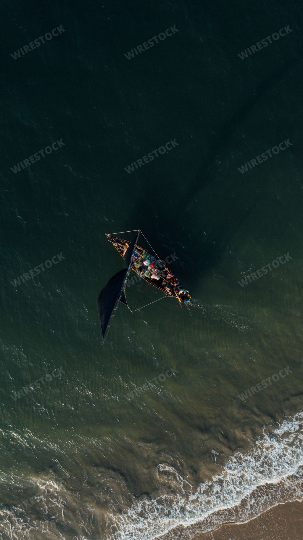 A drone vertical shot of small fishing boat on the sea