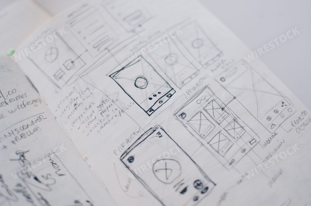 A closeup shot of UI/UX draft sheet drawings in a copybook