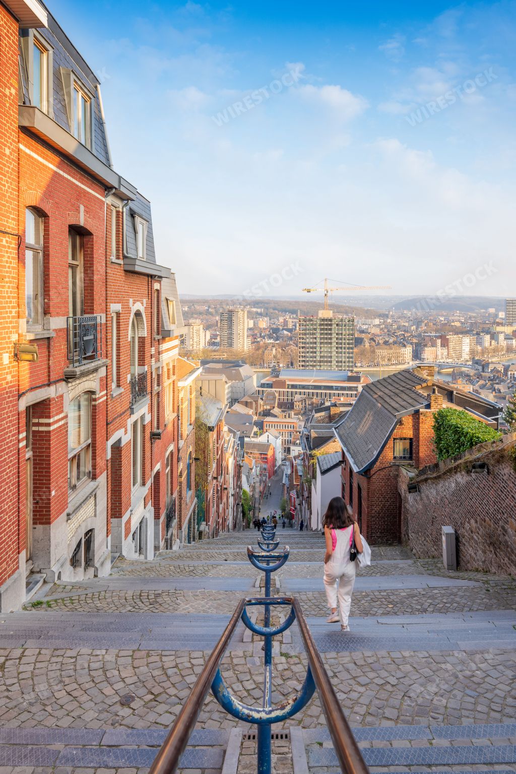 A scenic view of a female walking down the Montagne de Bueren stairway in Liege, Belgium