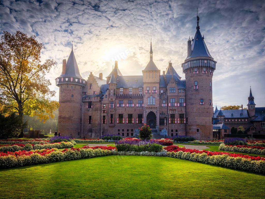 A breathtaking view of the Castle De Haar with a green garden around it in Utrecht, Netherlands