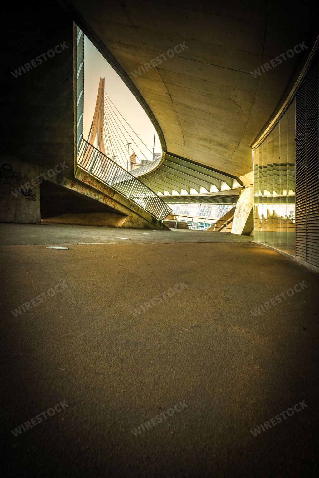 A vertical shot of walkways found under the Erasmusbrug bridge in Rotterdam, Netherlands