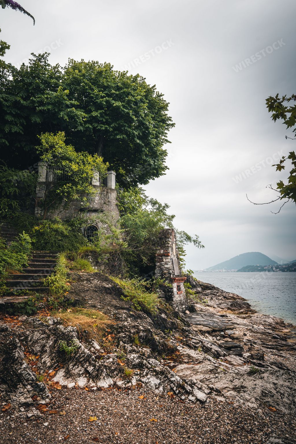 A small brick house near the lake shore on a gloomy day