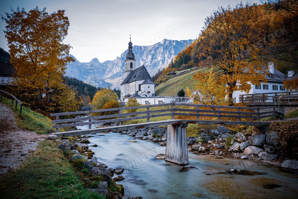 A scenic view of a bridge over a river near Parish Church of St. Sebastian in Berchtesgaden, Germany