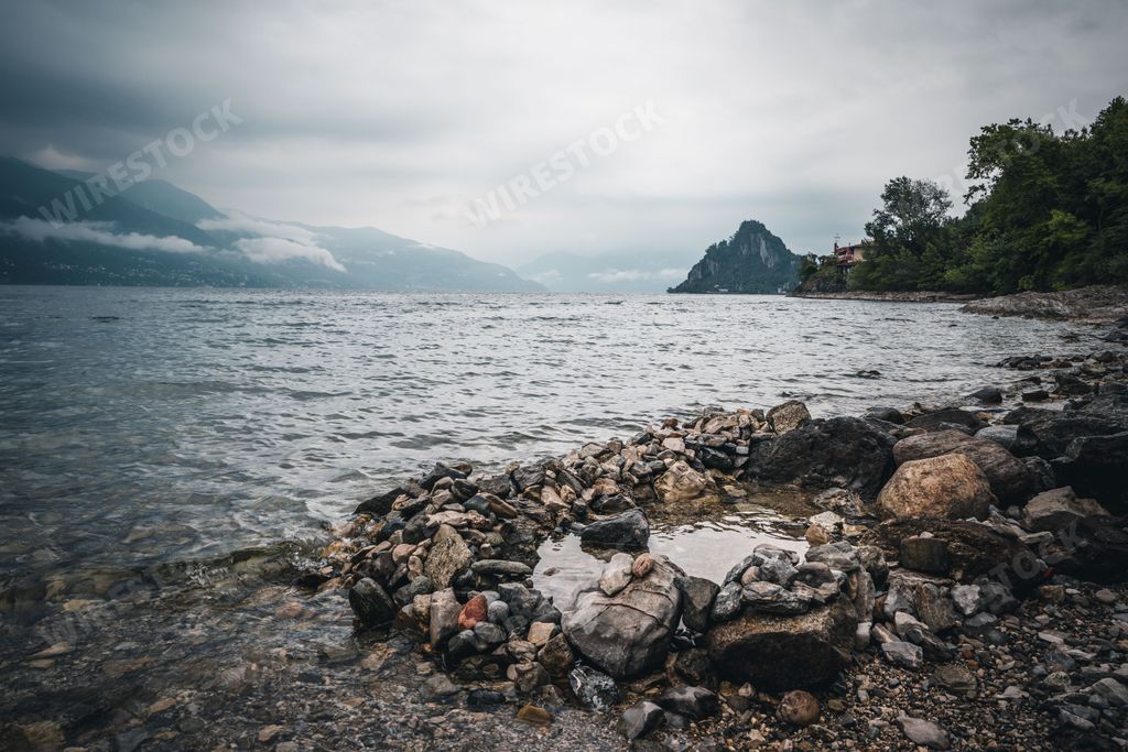 A big stone near the lake shore on a gloomy day