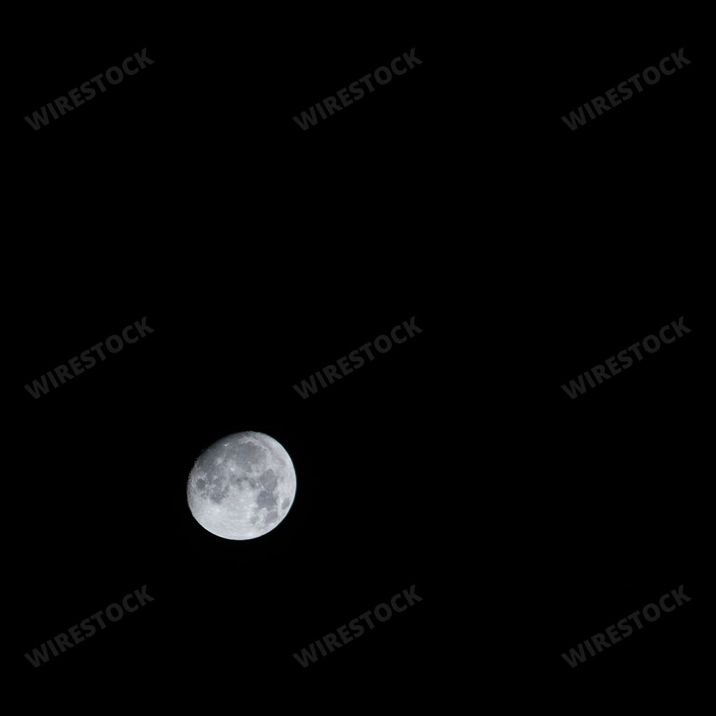 A closeup of the beautiful grey moon in the pitch black dark sky