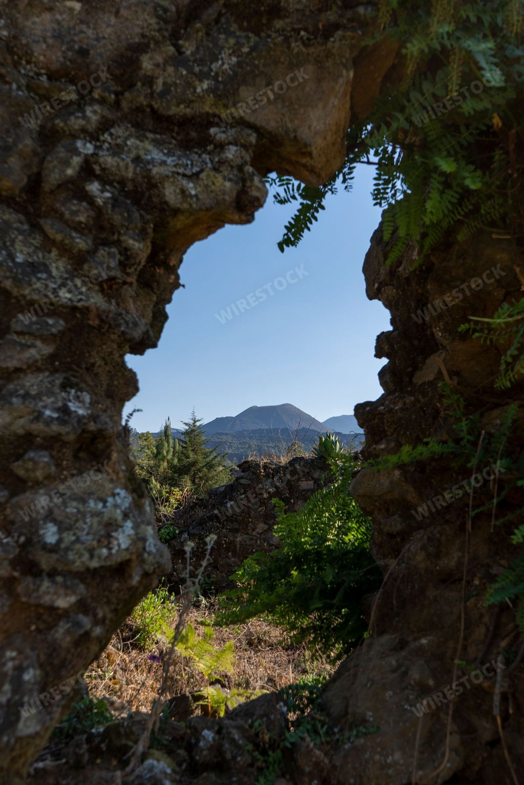 A framed view of Paricutin volcano under clear blue sky, Michoacan, Mexico