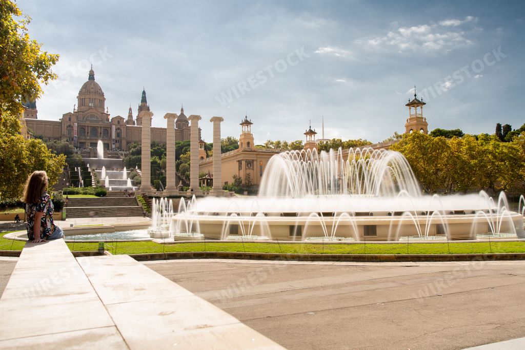 The Magic Fountain of Montjuic in Barcelona, Spain under sunlight with a palace in the background