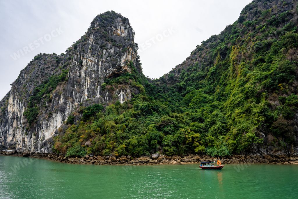 An aerial view of a cruise ship navigating through Halong Bay in Vietnam, Southeast Asia