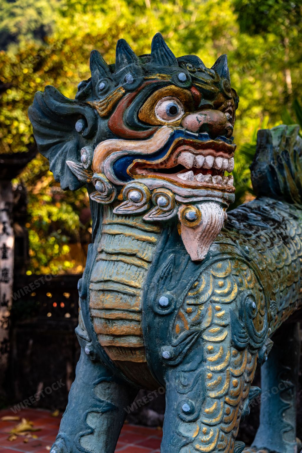 A detailed, blue-green dragon statue at the Thien Tru Temple near the Perfume Pagoda in Hanoi.